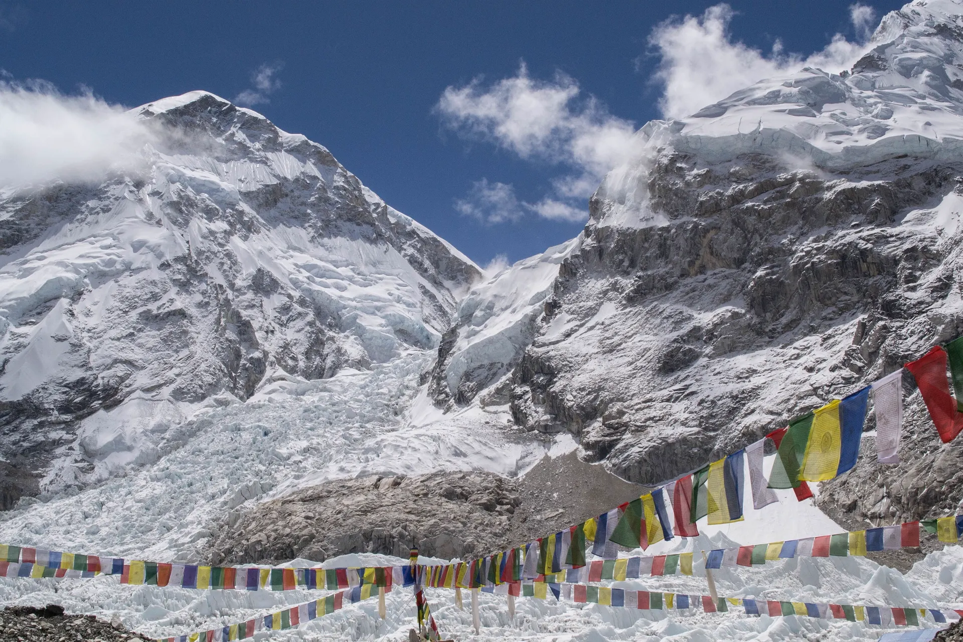 Prayer flags in the foreground with a glaciated peak beyond