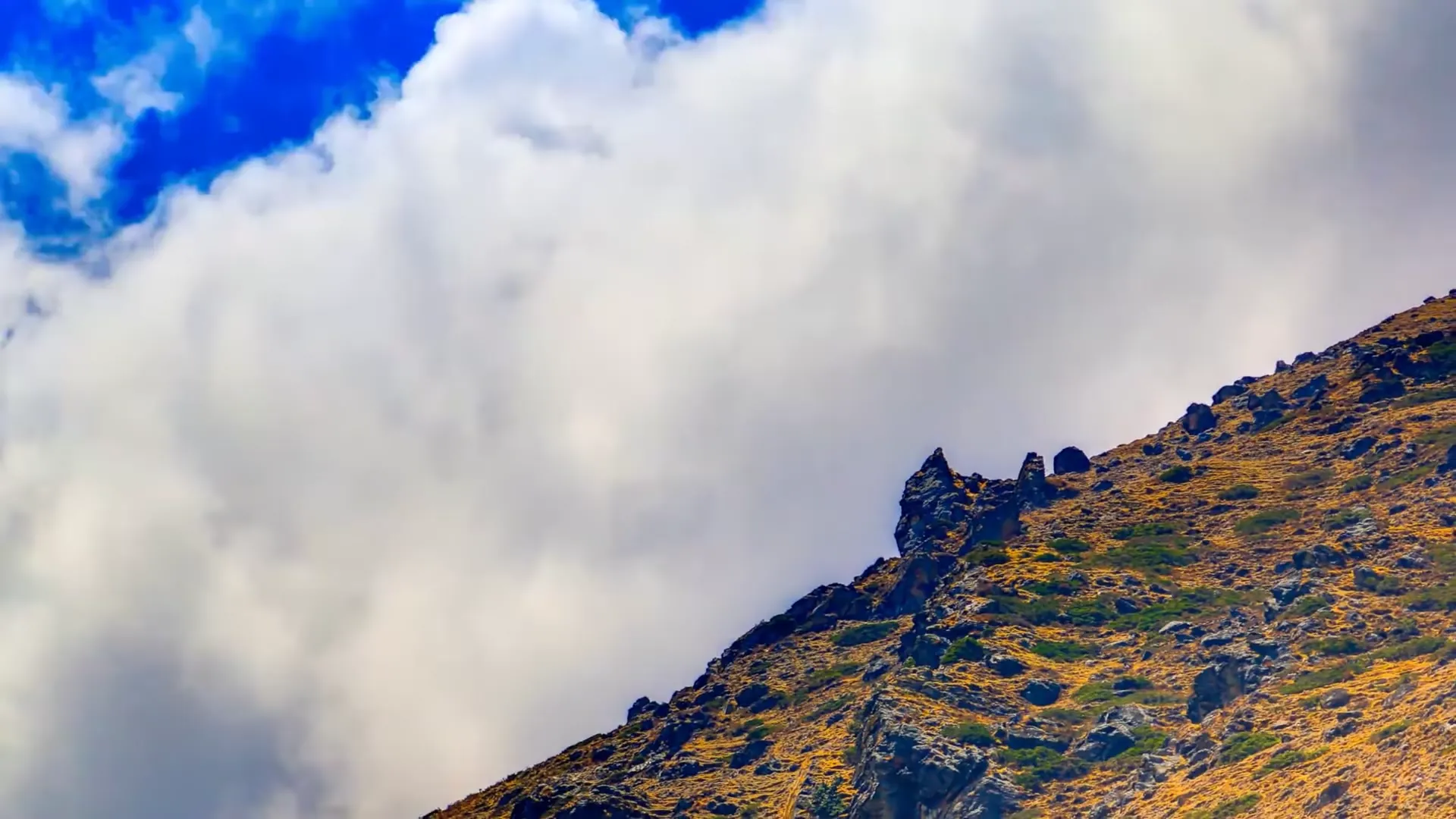 Snow-laden Himalayan ridge above the Khumbu Valley, clouds moving across the summit