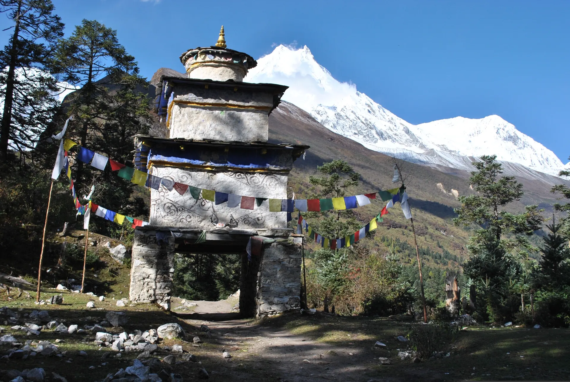 The gateway chorten at Ro village with Manaslu's summit rising behind